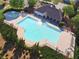 Aerial view of a large, sparkling community pool surrounded by lounge chairs and lush greenery at 150 Ivy Chase Loop, Dallas, GA 30157