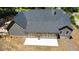 An aerial view of a single-story home with a spacious backyard and patio, surrounded by lush greenery at 5950 Lynfield Dr, Atlanta, GA 30349