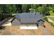 An aerial view of a single-story home with a spacious backyard and patio, surrounded by lush greenery at 5950 Lynfield Dr, Atlanta, GA 30349