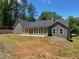 Exterior view of the back of the house, highlighting the large backyard and patio at 5950 Lynfield Dr, Atlanta, GA 30349
