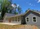 Backyard view of home, showing the covered patio and multiple windows that bring in lots of light at 5950 Lynfield Dr, Atlanta, GA 30349