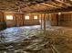 Unfinished basement with visible wooden beams, concrete block foundation and covering of plastic vapor barrier at 5950 Lynfield Dr, Atlanta, GA 30349