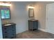 Bathroom with double vanities, granite counters, decorative mirrors, and modern lighting at 5950 Lynfield Dr, Atlanta, GA 30349