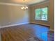 Elegant dining room area featuring hardwood flooring, decorative lighting, and large windows at 5950 Lynfield Dr, Atlanta, GA 30349