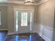 Elegant foyer with decorative molding, chandelier, and glass front door at 5950 Lynfield Dr, Atlanta, GA 30349