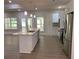 This kitchen offers an expansive view and features an island with sink, stainless steel appliances, and light hardwood floors at 5950 Lynfield Dr, Atlanta, GA 30349