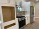 A well-equipped kitchen showcases stainless steel appliances, modern backsplash, and sleek white cabinetry, with a built-in oven space at 5950 Lynfield Dr, Atlanta, GA 30349