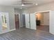 Open living room with double doors, tile flooring, and hardwood floors with access to bathroom at 5950 Lynfield Dr, Atlanta, GA 30349