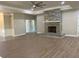 Spacious living room with a decorative fireplace, hardwood floors, and ample natural light at 5950 Lynfield Dr, Atlanta, GA 30349