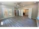 Open living room with double doors, tile flooring, and hardwood floors with access to bathroom at 5950 Lynfield Dr, Atlanta, GA 30349