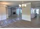 Spacious living room with hardwood flooring, fireplace, and modern chandelier at 5950 Lynfield Dr, Atlanta, GA 30349
