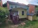 View of the back of the house, featuring a small storage shed, and screened in porch at 115 Davis Mill Ct, Lawrenceville, GA 30044