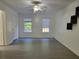 Neutral bedroom featuring vinyl floors, two windows and a ceiling fan at 115 Davis Mill Ct, Lawrenceville, GA 30044