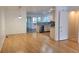 Open dining area with hardwood floors and a view into the kitchen with stainless steel appliances at 115 Davis Mill Ct, Lawrenceville, GA 30044
