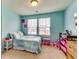 Bright bedroom featuring blue walls, carpeted floors, and natural light from the double windows at 1155 Magnolia Gardens Walk, Mcdonough, GA 30253