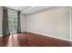 Bright bedroom with hardwood floors and double doors leading to a balcony at 325 E Paces Ferry Ne Rd # 313, Atlanta, GA 30305