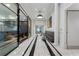 This hallway features high ceilings, modern lighting fixtures, and black and white tile at 325 E Paces Ferry Ne Rd # 313, Atlanta, GA 30305