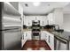 Well-lit kitchen featuring stainless steel appliances, granite countertops, and dark backsplash at 325 E Paces Ferry Ne Rd # 313, Atlanta, GA 30305