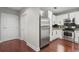 Cozy kitchen featuring white cabinets, stainless steel appliances, and hardwood floors at 325 E Paces Ferry Ne Rd # 313, Atlanta, GA 30305
