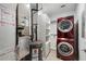 This laundry room boasts stacked red washer/dryer units and built-in shelving at 325 E Paces Ferry Ne Rd # 313, Atlanta, GA 30305