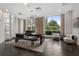 This lounge includes a unique light fixture, oversized windows, and modern seating options at 325 E Paces Ferry Ne Rd # 313, Atlanta, GA 30305