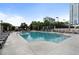 Community swimming pool with lounge seating with modern apartment buildings in the background at 325 E Paces Ferry Ne Rd # 313, Atlanta, GA 30305