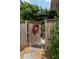Backyard gate leading to an outdoor seating area, enhanced by a wooden pergola and lush greenery at 3734 Paige Ne Way # 10, Atlanta, GA 30319