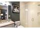 Modern bathroom featuring tiled shower, gray vanity with sink, and stylish lighting at 3734 Paige Ne Way # 10, Atlanta, GA 30319