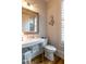 Charming powder room with a pedestal sink, toilet, and stylish mirror at 3734 Paige Ne Way # 10, Atlanta, GA 30319
