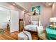 Bright bedroom with wood floors and a four poster bed is decorated with unique art at 3734 Paige Ne Way # 10, Atlanta, GA 30319