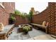 Brick patio with stone benches, a central fire pit, and lush greenery, creating a cozy outdoor gathering space at 3734 Paige Ne Way # 10, Atlanta, GA 30319