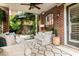 Brick patio featuring a ceiling fan, stylish furniture, a patterned rug, and lush greenery for outdoor relaxation at 3734 Paige Ne Way # 10, Atlanta, GA 30319