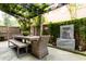 Inviting outdoor patio with shaded dining area, lush greenery, and decorative water feature at 3734 Paige Ne Way # 10, Atlanta, GA 30319