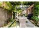 Back patio dining area with wood beam pergola, custom bench seating, and stone fountain at 3734 Paige Ne Way # 10, Atlanta, GA 30319