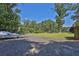 Backyard of home features a gravel driveway with a lush green lawn at 3765 Cannonwolde Dr, Snellville, GA 30039