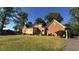 A spacious backyard with mature trees surrounds a brick and siding home, offering outdoor space at 3765 Cannonwolde Dr, Snellville, GA 30039