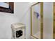Bathroom area with gold-trimmed glass shower and small side table at 3765 Cannonwolde Dr, Snellville, GA 30039