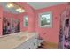 The bathroom features a white vanity, floral shower curtain, and ample natural light at 3765 Cannonwolde Dr, Snellville, GA 30039