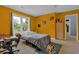 This bedroom has carpet floors, natural light and yellow accent walls at 3765 Cannonwolde Dr, Snellville, GA 30039