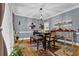 Dining room with hardwood floors, chair railing, and a decorative light fixture above the table at 3765 Cannonwolde Dr, Snellville, GA 30039