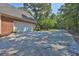 Brick house featuring a long driveway with attached three car garage at 3765 Cannonwolde Dr, Snellville, GA 30039