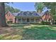 Charming brick home with dormer windows and a welcoming front porch at 3765 Cannonwolde Dr, Snellville, GA 30039