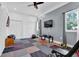 Bright home gym features colorful flooring, a ceiling fan, and large windows with natural light at 3765 Cannonwolde Dr, Snellville, GA 30039