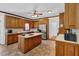 Traditional kitchen with oak cabinets, tile flooring, and an island with cooktop at 3765 Cannonwolde Dr, Snellville, GA 30039