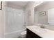 Bright bathroom featuring a shower-tub combo with a clear shower curtain and a vanity with good storage at 4022 Roberts Crest Dr, Suwanee, GA 30024