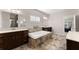 Bathroom featuring a tiled soaking tub, and double vanities with ample counter space at 4022 Roberts Crest Dr, Suwanee, GA 30024