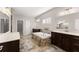 Bathroom with a soaking tub, double vanities, and tile flooring, creating a luxurious experience at 4022 Roberts Crest Dr, Suwanee, GA 30024