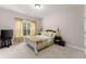 Bright bedroom is furnished with comfortable queen bed and TV on stand at 4022 Roberts Crest Dr, Suwanee, GA 30024