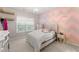 This bedroom features a soft bed, natural light from the window, and custom paintwork at 4022 Roberts Crest Dr, Suwanee, GA 30024