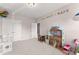 Spacious bedroom features neutral walls, plush carpet, double doors, and fun toy accents at 4022 Roberts Crest Dr, Suwanee, GA 30024